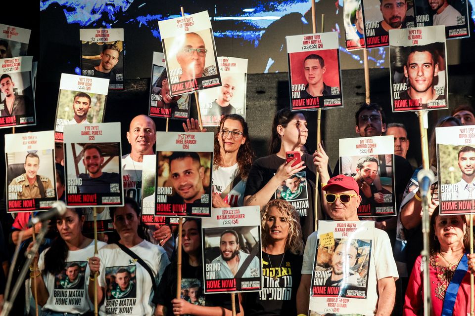 People hold placards with pictures of hostages who were kidnapped in the deadly October 7, 2023 attack by Hamas, in Tel Aviv, Israel. Photo: Reuters/Ronen Zvulun